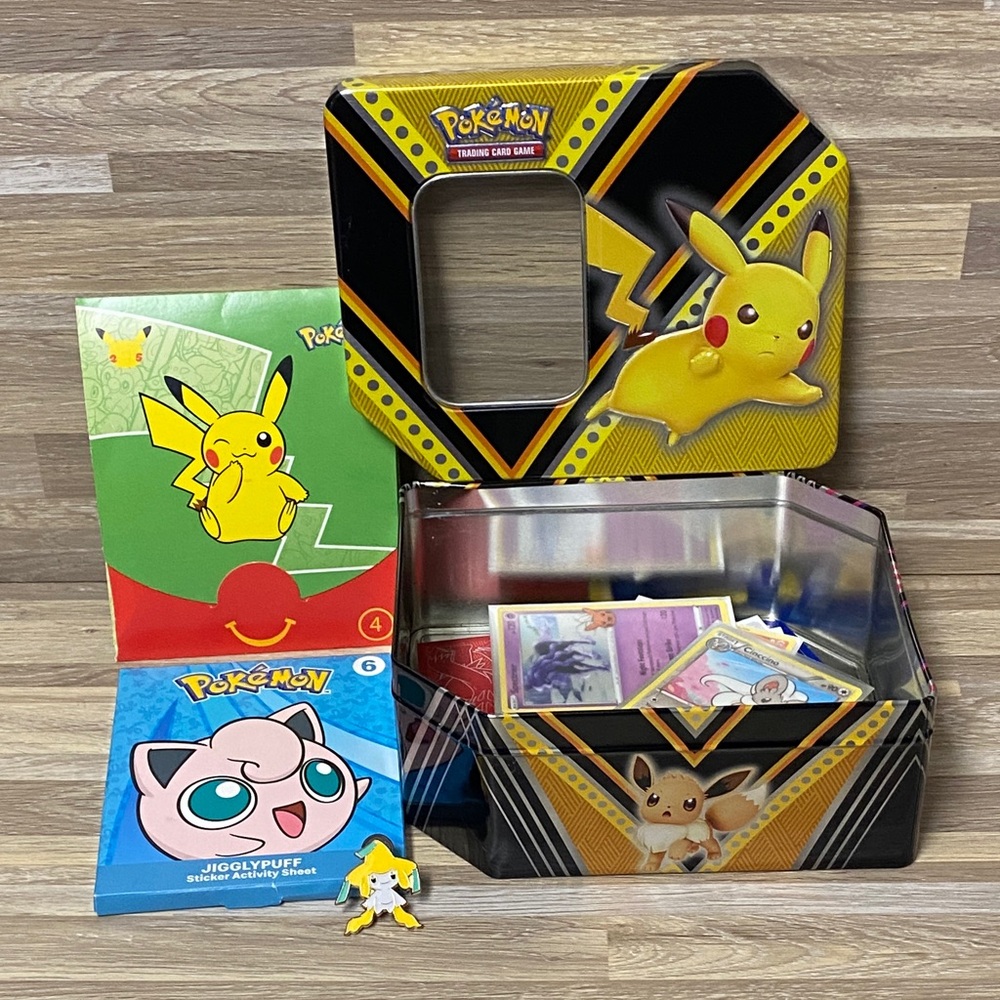 Pokemon Pikachu Yellow and Black Card Tin filled with cards and Pokémon pin